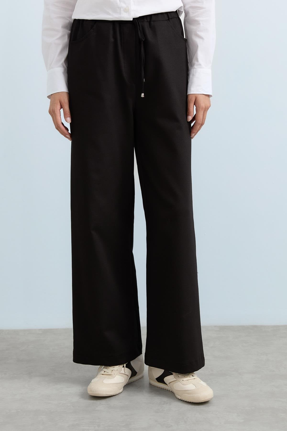 beli-lastikli-bol-paca-pantolon-siyah-237000.jpg